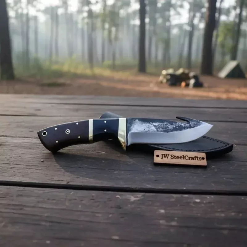 Gut hook knife with wood and brass handle.